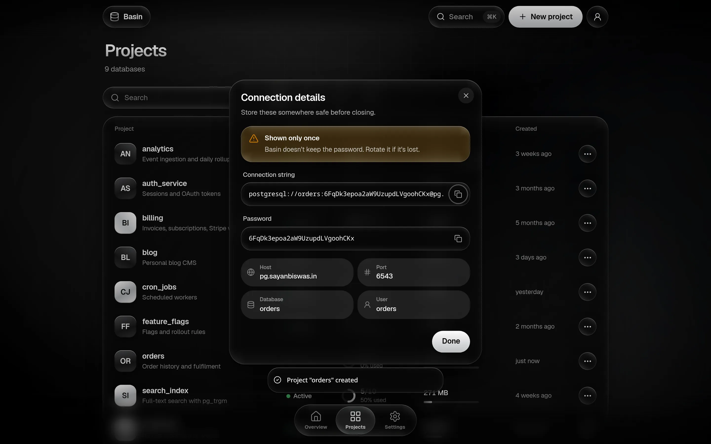 The connection details dialog with a shown-only-once warning, a copyable connection string and password, and host, port, database and user.