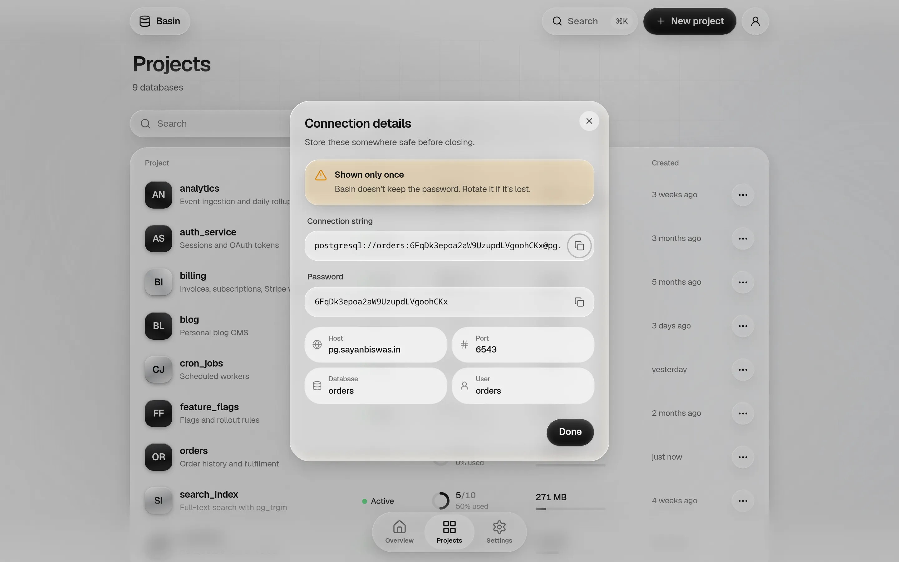 The connection details dialog with a shown-only-once warning, a copyable connection string and password, and host, port, database and user.